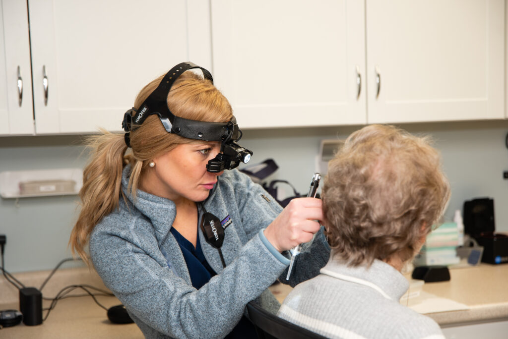 An audiologist caring for a patient